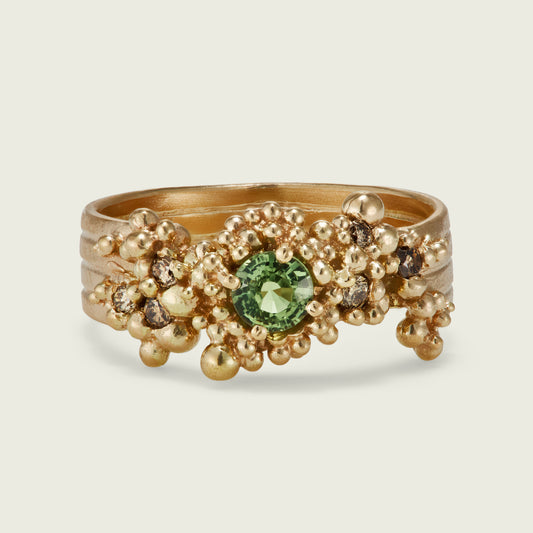 Created for a client in Canada this is my first 14ct gold Whorl Ring. The warm tones work beautifully, swirling around the gorgeous earthy green and Champagne Sapphires handpicked by my client.
