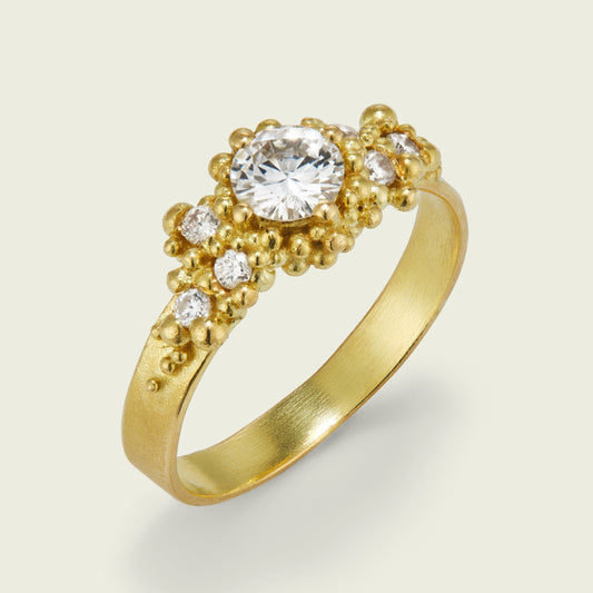 My client asked me to reimagine her existing engagement ring into something more contemporary. Using her own buttery 18ct yellow gold, a luminous 5mm diamond, and six sparkling side stones, I created a dream hybrid of three of my signature designs — Wave, Whorl, and Cluster. I’m completely smitten with the result.