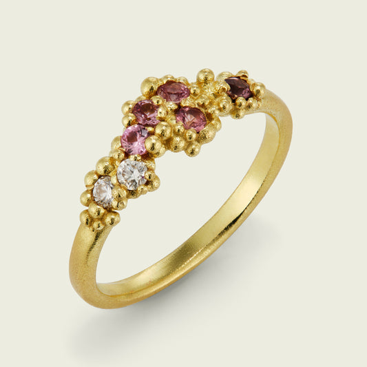 The sea of tonal cognac sapphires and white diamonds works beautifully in this bespoke granule ring. The gently curved form allows the design to nestle perfectly with my client’s engagement ring. 'The ring just arrived and it’s stunning! It goes so well with my engagement ring but also as a standalone piece - beautiful.’