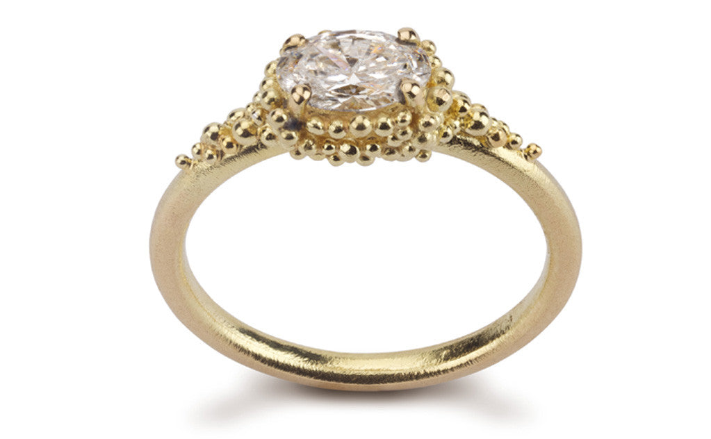 1. Cluster Ring - 18ct yellow gold and oval diamond